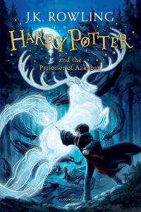 Illustrated cover of Harry Potter and the Prisoner of Azkaban by J.K. Rowling, showing Harry casting a spell that creates a glowing, ghostly stag, with a dark, swirling forest background.