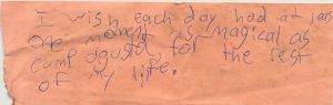 A handwritten note on pink paper reads: I wish each day had at least one moment as magical as Camp Augusta, for the rest of my life.