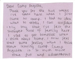 A handwritten letter on purple paper expresses gratitude to Camp Augusta, describing how the writer now feels a strong sense of family at camp and misses it as much as they used to miss home.