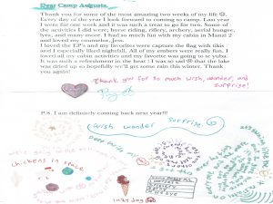 A handwritten thank-you letter from a camper to staff, decorated with colorful doodles of hearts, stars, a dog, a chicken in space, and expressive words like “surprise,” “wonder,” and “wish.”.