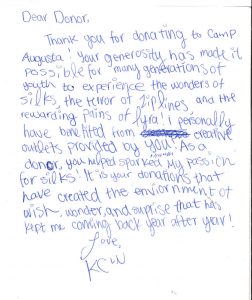 A handwritten thank you letter to a donor, expressing gratitude for supporting Camp Augusta. The writer shares how donations make creative experiences like silks, zip lines, and lyra possible, and signs off as KCW.