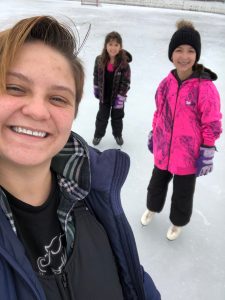 Dani ice skating with her two sisters.