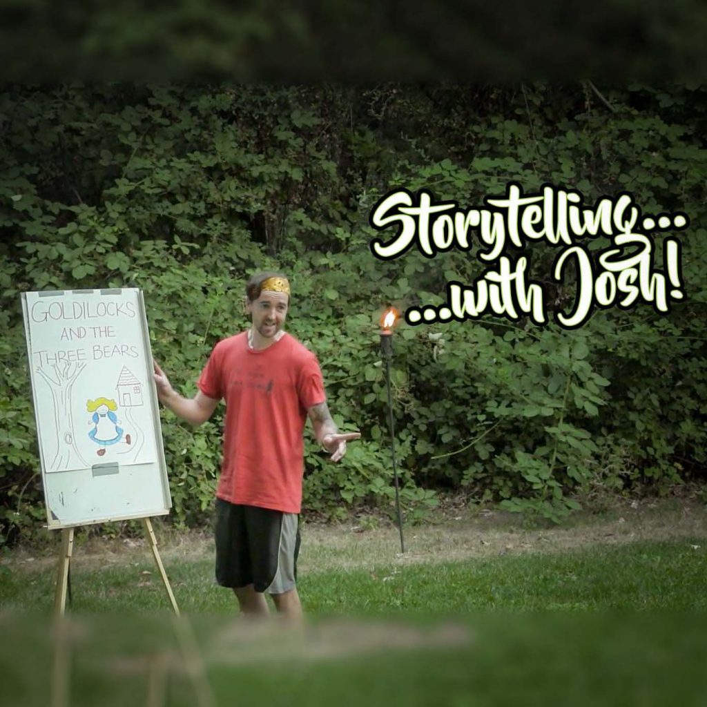 A man in a red shirt stands next to a flipchart with Goldilocks and the Three Bears drawn on it. He gestures enthusiastically outdoors, with the text Storytelling...with Josh! over the image.