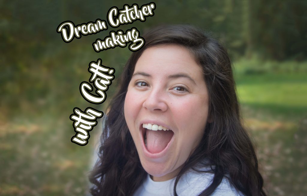 A woman with long dark hair smiles widely outdoors, with text overlaid that says Dream Catcher making with Cat! The background is blurred greenery.