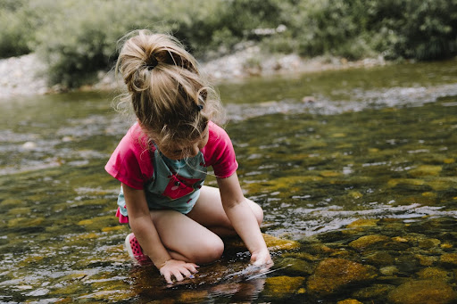 Child Playing In River 